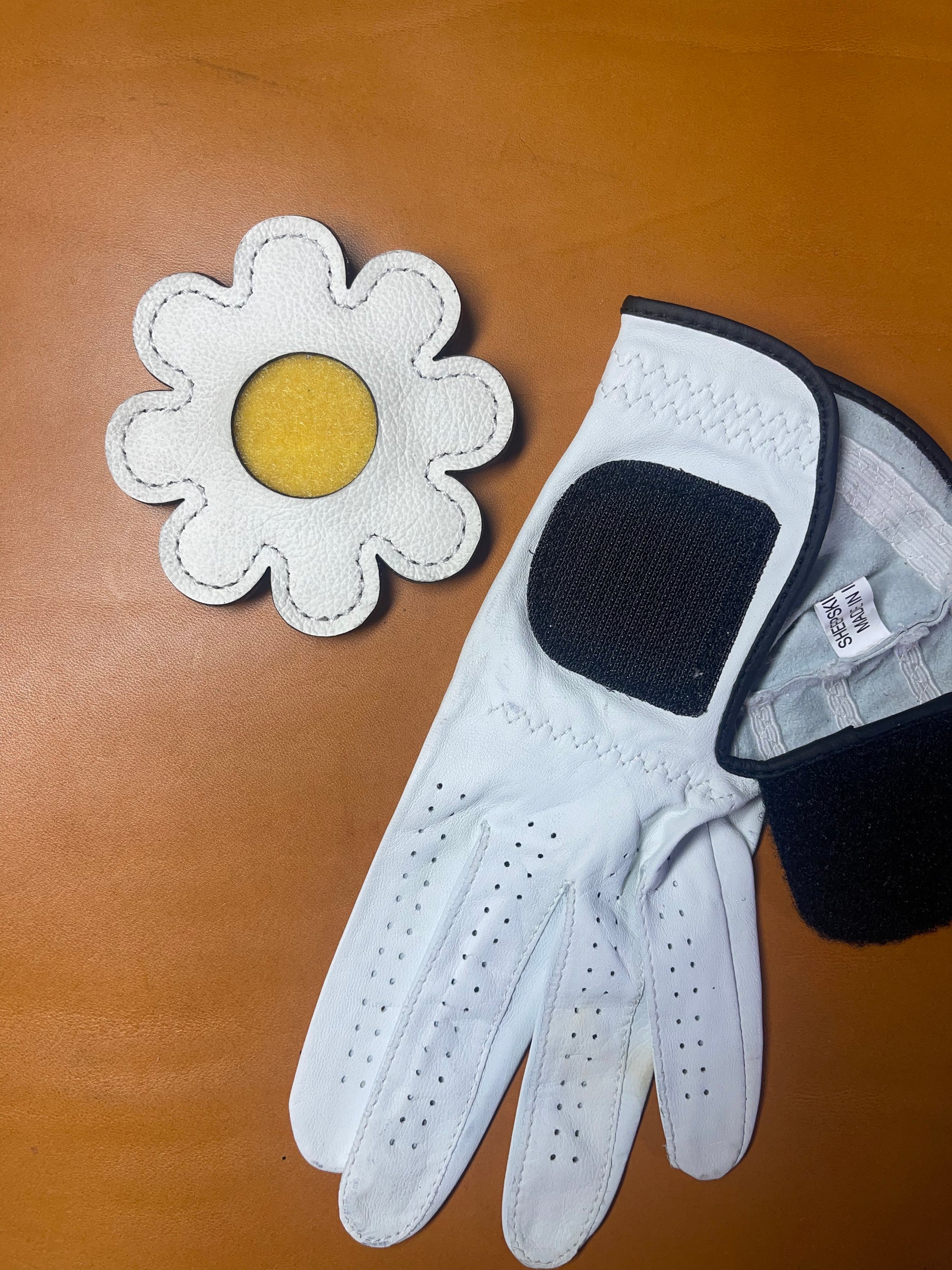 Daisy glove holder displayed flat on a neutral background, highlighting its craftsmanship and design.